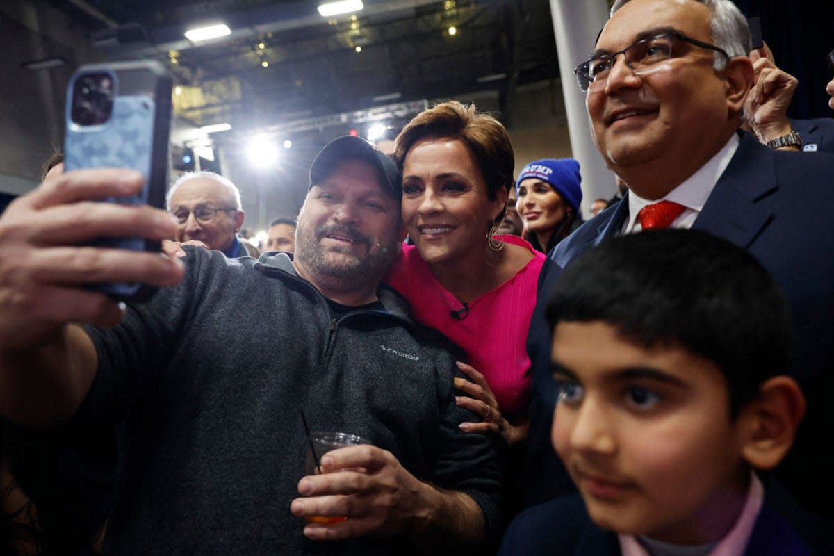 Candidate for U.S. Senate Kari Lake takes a photo with attendees at the caucus night party hosted by Republican presidential candidate former U.S. President Donald Trump at the Iowa Events Center on Jan. 15, 2024 in Des Moines.