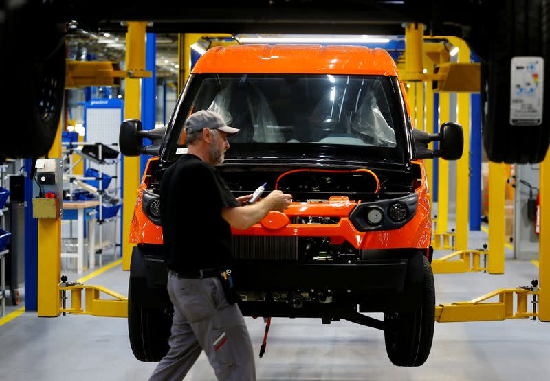 FILE PHOTO: A worker assembles a StreetScooter electric delivery van on the production line during an opening tour in Dueren near Cologne