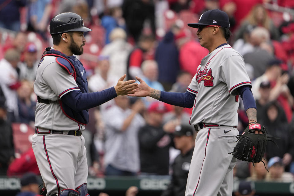 Atlanta Braves relief pitcher Jesse Chavez, right, and catcher Travis d'Arnaud celebrate a 5-2 victory over the St. Louis Cardinals in a baseball game Wednesday, April 5, 2023, in St. Louis. (AP Photo/Jeff Roberson)