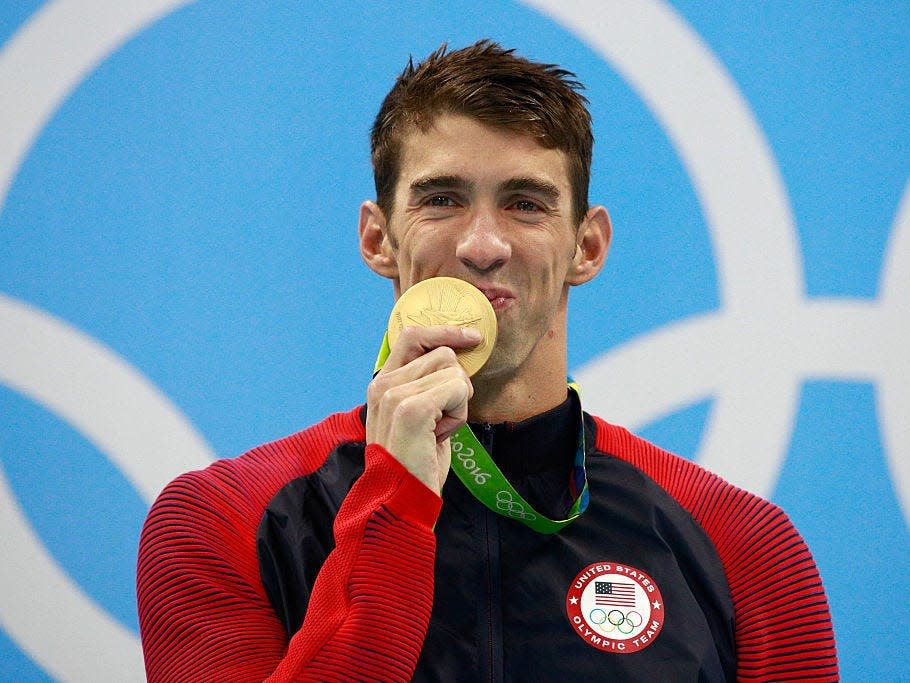 Olympic swimmer Michael Phelps holds a gold medal