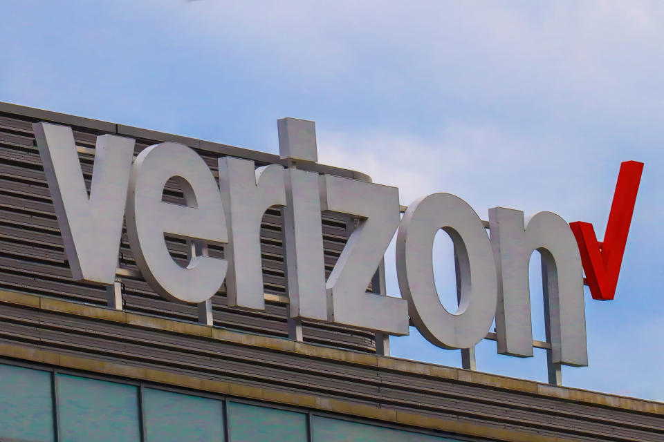  Verizon logo on a building with a blue sky above. 