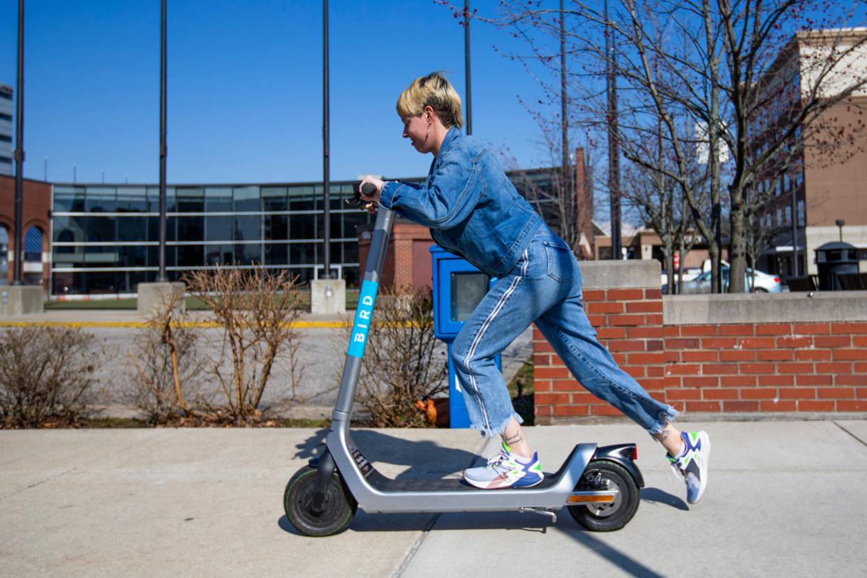 Melina Hendrickson gets ready to use a Bird Scooter in downtown South Bend.