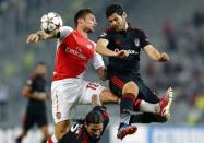 Arsenal's Olivier Giroud (L) fights for the ball with of Besiktas' Pedro Franco (R) and Ersan Gulum (bottom) during the first leg of their Champions League qualifying soccer match at Ataturk Olympic stadium in Istanbul August 19, 2014. REUTERS/Murad Sezer