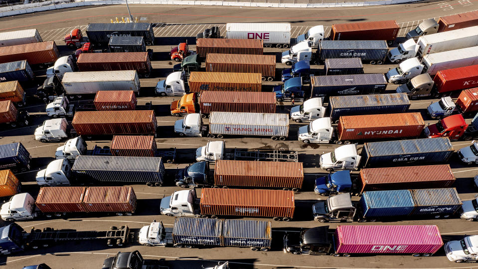 Trucks line up to enter a Port of Oakland shipping terminal on Wednesday, Nov. 10, 2021, in Oakland, Calif. Intense demand for products has led to a backlog of container ships outside the nation's two largest ports along the Southern California coast. (AP Photo/Noah Berger)