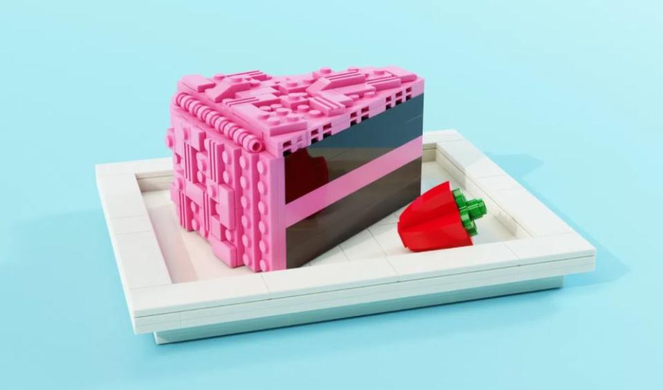 A slice of LEGO chocolate cake with pink frosting.