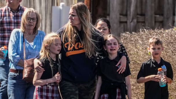 PHOTO: Children and a woman depart the reunification center at the Woodmont Baptist church after a school shooting, Mar. 27, 2023, in Nashville, Tenn. (John Bazemore/AP)