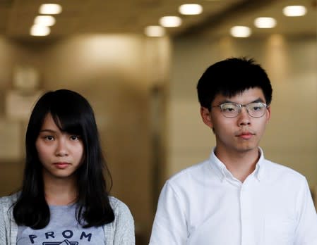 Pro-democracy activists Joshua Wong and Agnes Chow leave the Eastern Court after being released on bail in Hong Kong
