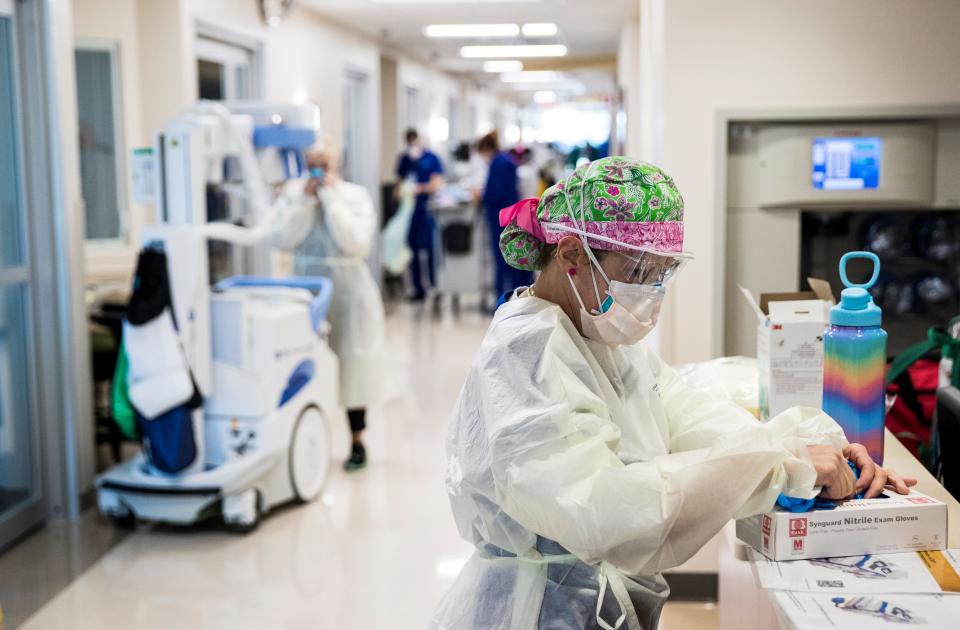 Ivette Torres, a registered nurse in the intensive care unit at Gulf Coast Medical Center, prepares to treat a COVID-19 patient in Fort Myers, Florida, on Aug. 13. All the hospitals in Southwest Florida are seeing an influx of COVID-19 patients, most of them unvaccinated. (Andrew West/The News-Press)