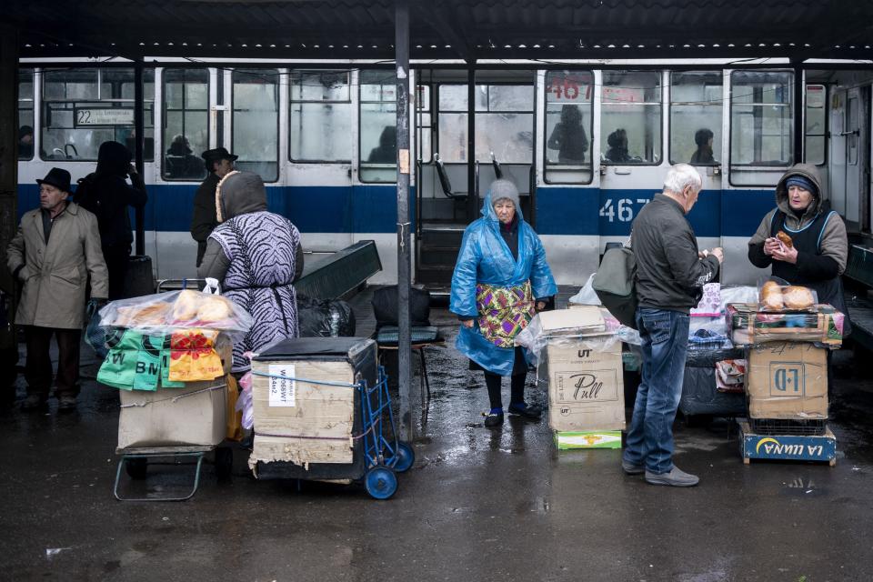 In this photo taken on Monday, April 15, 2019, women sell homemade meat patties at a railway station in Kryvyi Rih, in eastern Ukraine. The country votes Sunday, April 21, on whether to return President Petro Poroshenko for another 5-year term, or go with Volodymyr Zelenskiy, an actor and comedian native to Kryvyi Rih. (AP Photo/Evgeniy Maloletka)