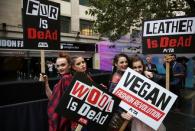 Models hold placards as they demonstrate against the use of fur and leather in clothing at a protest organised by PETA at London Fashion Week Spring/Summer 2017 in London, Britain September 16, 2016. REUTERS/Neil Hall