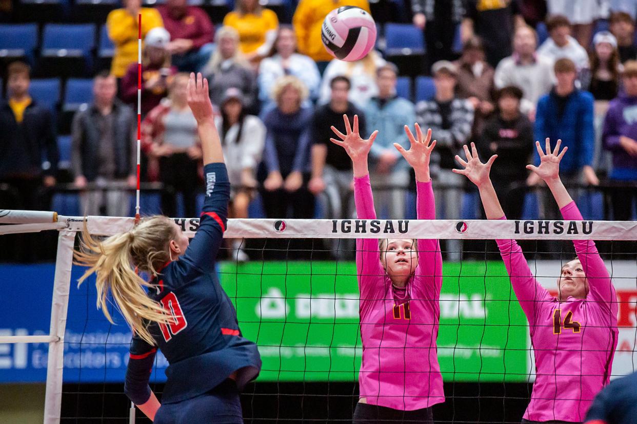 Urbandale's Lily Dykstra spikes while Ankeny's Tanith Roush and Myra Carlson try to block the ball during the Class 5A state volleyball quarterfinal last year.