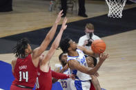 Pittsburgh's Femi Odukale (2) shoots after getting by Louisville's Dre Davis (14) and Samuell Williamson (10) during the second half of an NCAA college basketball game Tuesday, Dec. 22, 2020, in Pittsburgh. (AP Photo/Keith Srakocic)