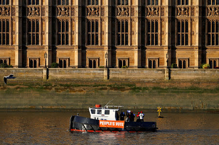 FILE PHOTO: Campaigners for a People's Vote demonstrate on a boat as it cruises along the River Thames in front of the Houses of Parliament in Westminster London, Britain, December 13, 2018. REUTERS/Phil Noble/File Photo