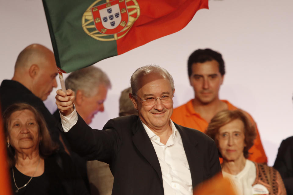 Rui Rio, leader of the Social Democratic Party, center, waves a Portuguese flag during an election campaign rally in Lisbon Friday, Oct. 4, 2019. Portugal will hold a general election on Oct. 6 in which voters will choose members of the next Portuguese parliament. (AP Photo/Armando Franca)