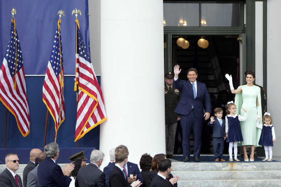 Florida Gov. Ron DeSantis, background left, waves as he arrives with his wife Casey, right, and their children Mason, Madison, and Mamie before his inauguration ceremony outside the Old Capitol Tuesday, Jan. 3, 2023, in Tallahassee, Fla. (AP Photo/Lynne Sladky)