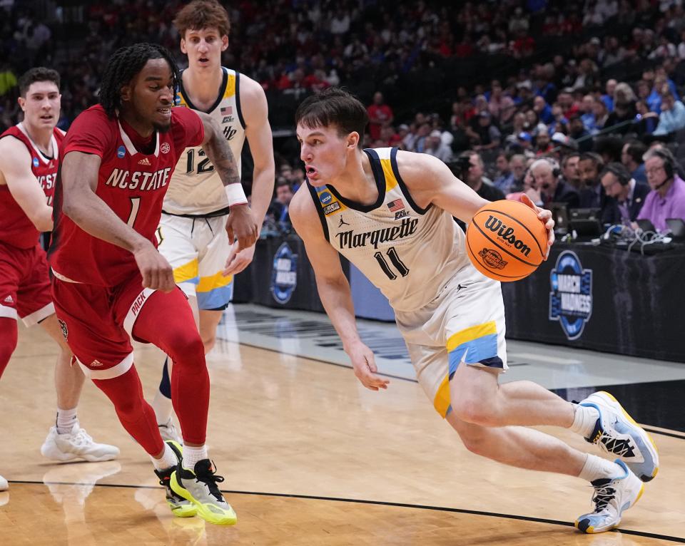 Marquette guard Tyler Kolek turns the corner on North Carolina State guard Jayden Taylor.