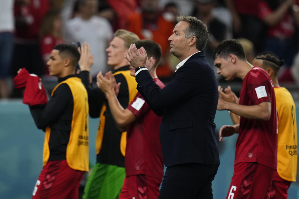 Denmark's head coach Kasper Hjulmand, center, applauds with teammates to supporters at the end of the World Cup group D soccer match between Denmark and Tunisia, at the Education City Stadium in Al Rayyan, Qatar, Tuesday, Nov. 22, 2022. The match ended in a 0-0 draw. (AP Photo/Manu Fernandez)
