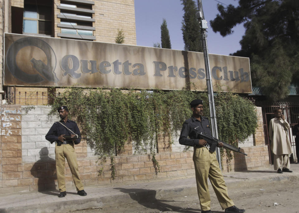 In this Friday, Sept. 14, 2012 photo, Pakistani security stand guard in front of the Press Club in Quetta, Pakistan. The telephone call to local journalists generally comes in the late evening. The voice on the other end is usually a Sunni militant with a statement he wants printed threatening of violence or claiming responsibility for attacks that already occurred. Journalists fear being killed if they don't print the messages. (AP Photo/Arshad Butt)