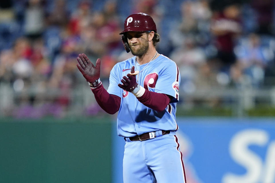 Philadelphia Phillies' Bryce Harper reacts after hitting an RBI-double against Chicago Cubs pitcher Manuel Rodriguez during the sixth inning of a baseball game, Thursday, Sept. 16, 2021, in Philadelphia. (AP Photo/Matt Slocum)