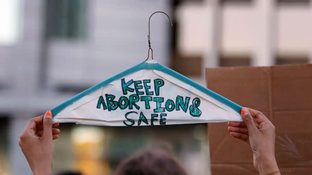 PHOTO: FILE - In this file photo taken, June 24, 2022, a person holds a metal coat hanger, a symbol of the reproductive rights movement, with the words 'Keep Abortions Safe' outside Lloyd D. George Federal Courthouse in Las Vegas, Nevada. (Ronda Churchill/AFP via Getty Images, FILE)