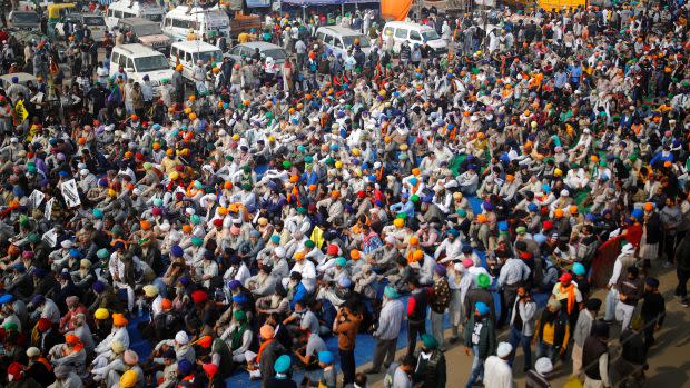 Farmers listen to a speaker during a protest against the newly passed farm bills at Singhu border near Delhi, India, December 5, 2020.