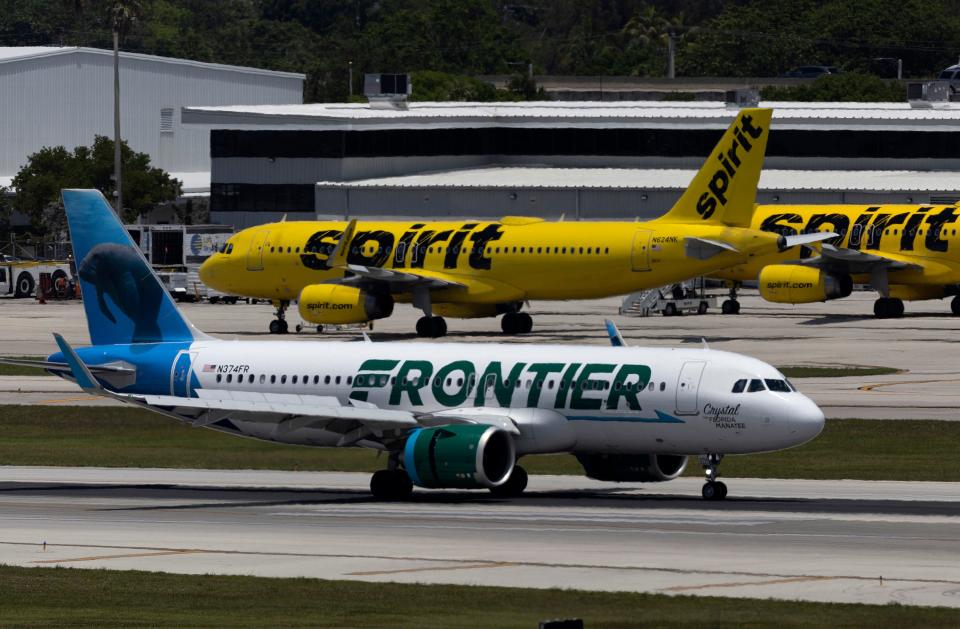 A Frontier Airlines plane near a Spirit Airlines plane at the Fort Lauderdale-Hollywood International Airport on May 16, 2022 in Fort Lauderdale, Florida.