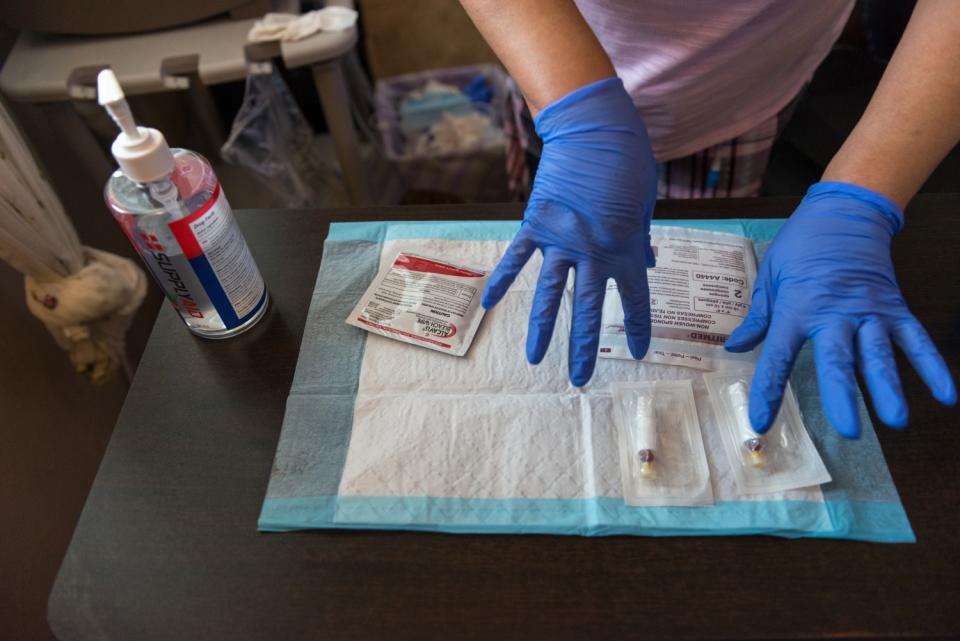 Maria Duenas readies her home dialysis supplies.