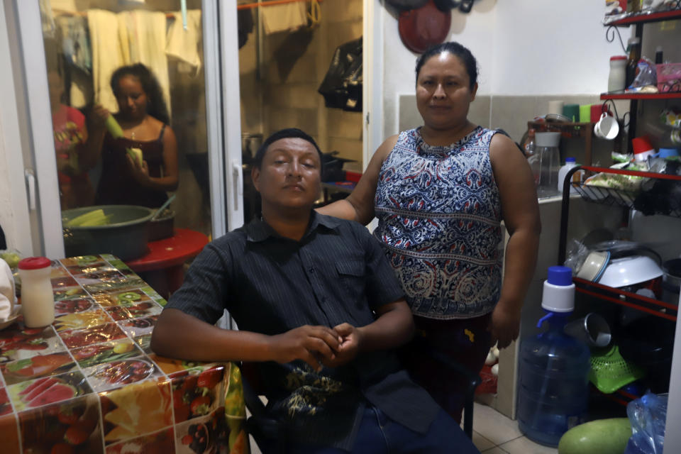 Ramon Sanchez and his wife Eulalia Garcia, pose for a photo in their new home donated by the government, in the private residential development Ciudad Marsella, El Salvador, Wednesday, Aug. 4, 2021. Garcia, a survivor of a landslide that destroyed her home in Los Angelitos, said she was stunned when she opened an envelope in December 2020 to find an invitation from the president of El Salvador, to receive a surprise Christmas gift, which turned out to be the new home. (AP Photo/Salvador Melendez)