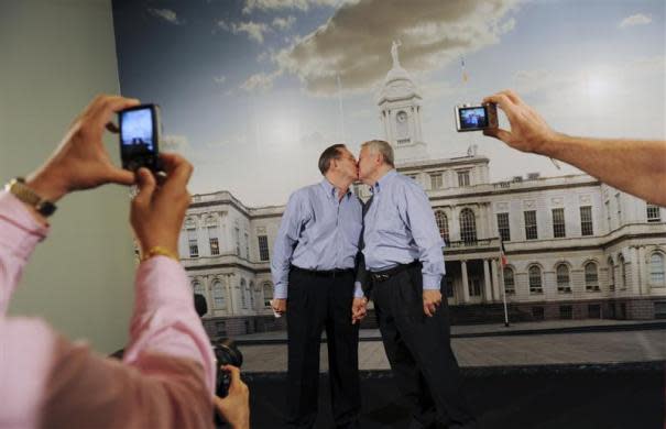 Ray Durand (L) and his partner Dale Shields kiss while having their picture taken after their wedding ceremony at the City Clerk's Office for their wedding ceremony in New York July 24, 2011.