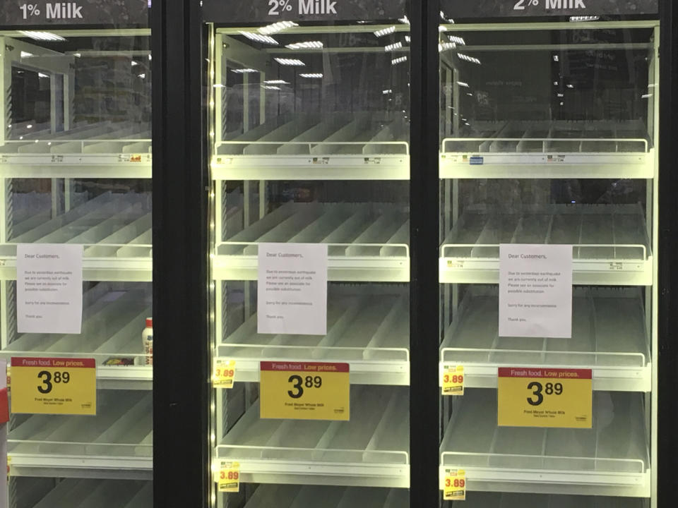 Empty milk refrigerators are shown at a grocery store in Anchorage, Alaska, on Sunday, Dec. 2, 2018, two days after a magnitude 7.0 earthquake was centered about 7 miles north of the city. Anchorage officials urged residents not to stock up and hoard supplies because the supply chain of goods was not interrupted. (AP Photo/Mark Thiessen)