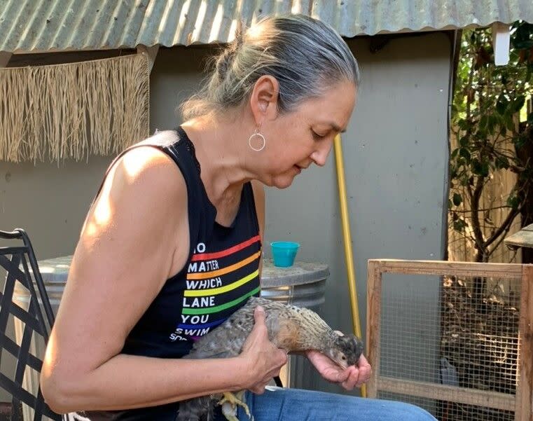 Deanna Lin cares for one of her backyard chickens.