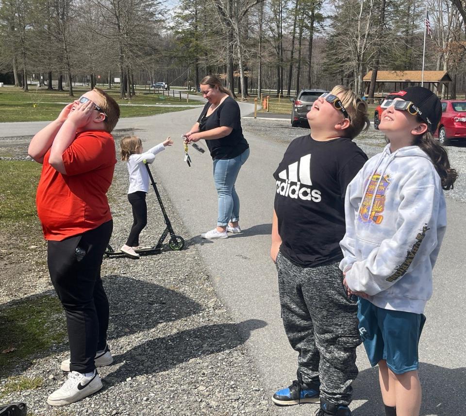 Watching the solar eclipse at Windber Recreation Park are, in the foreground left to right, Ben McClain, his brother Ryan McClain and Ryan's friend Sebastian Walter, all of Windber. In the background are Abby McClain and Brittney McClain.