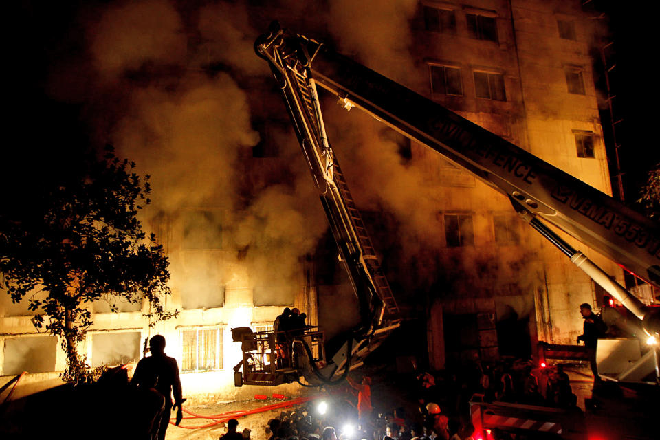 Bangladeshi firefighters battle a fire at a garment factory in the Savar neighborhood in Dhaka, Bangladesh, late Saturday, Nov. 24, 2012. At least 112 people were killed in a fire that raced through the multi-story garment factory just outside of Bangladesh's capital, an official said Sunday. (AP Photo/Hasan Raza)