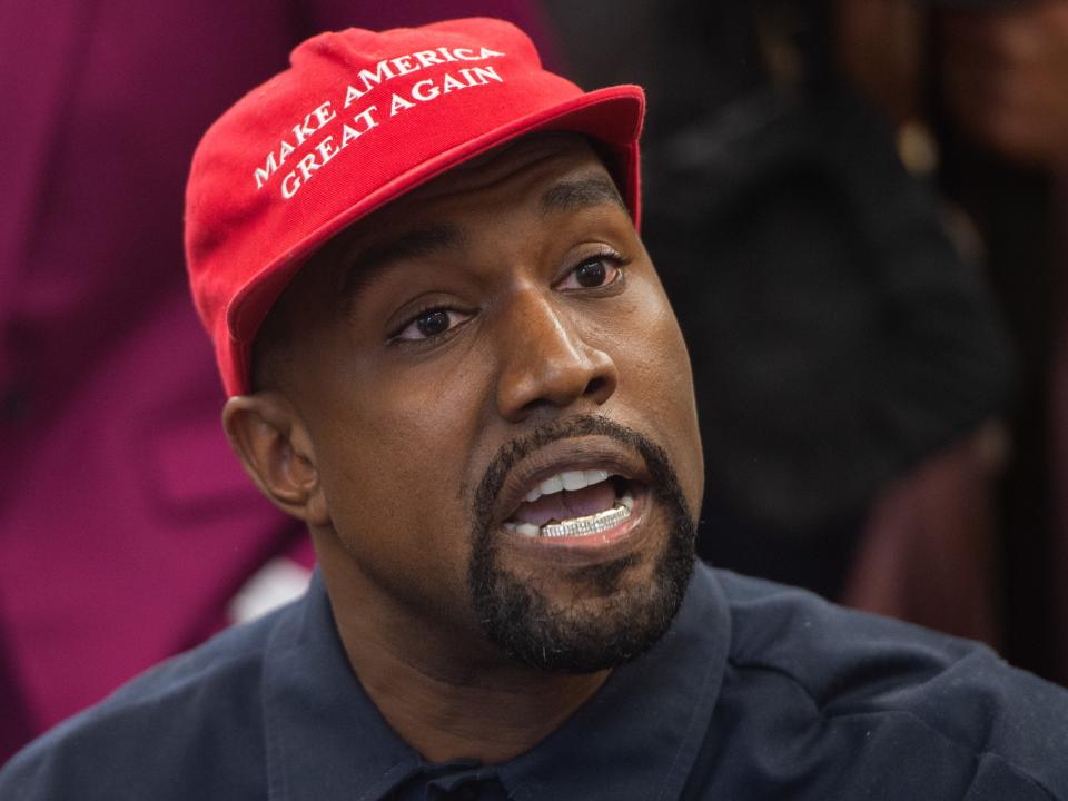 Kanye West in red MAGA Trump hat
