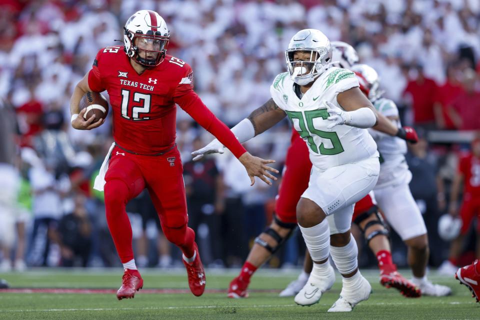Texas Tech quarterback Tyler Shough (12) runs the ball against Oregon defensive tackle Keyon Ware-Hudson (95) during the first half of an NCAA college football game, Saturday, Sept. 9, 2023, in Lubbock, Texas. 