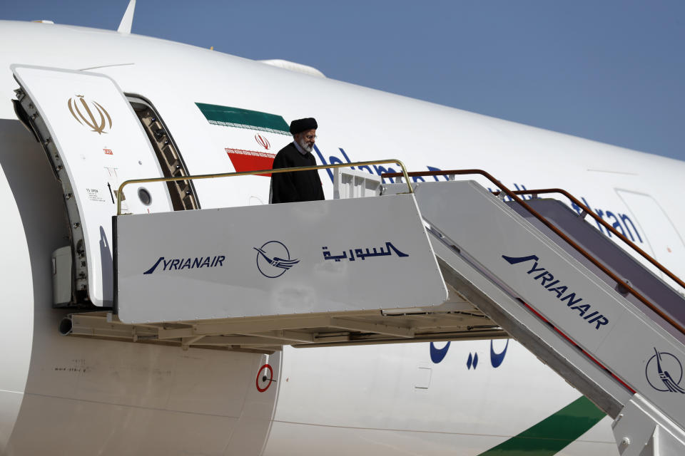 Iranian President Ebrahim Raisi steps off the plane as he arrives to the airport in Damascus, Syria, Wednesday, May 3, 2023. It is the first visit by an Iranian head of state to war-torn Syria since the beginning of the country's uprising-turned-civil-war in 2011, in which Tehran helped tip the balance of power to the government. (AP Photo/Omar Sanadiki)