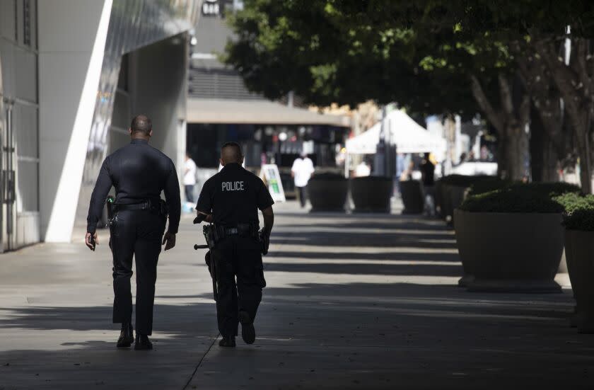 LOS ANGELES, CA - FEBRUARY 08: Los Angeles Police Department officers walk near the Convention Center on Tuesday, Feb. 8, 2022. U.S. Rep. Karen Bass said that as mayor she would move 250 Los Angeles police officers out of desk jobs and into patrols, while ensuring that the department returns to its authorized strength of 9,700 officers. (Myung J. Chun / Los Angeles Times)