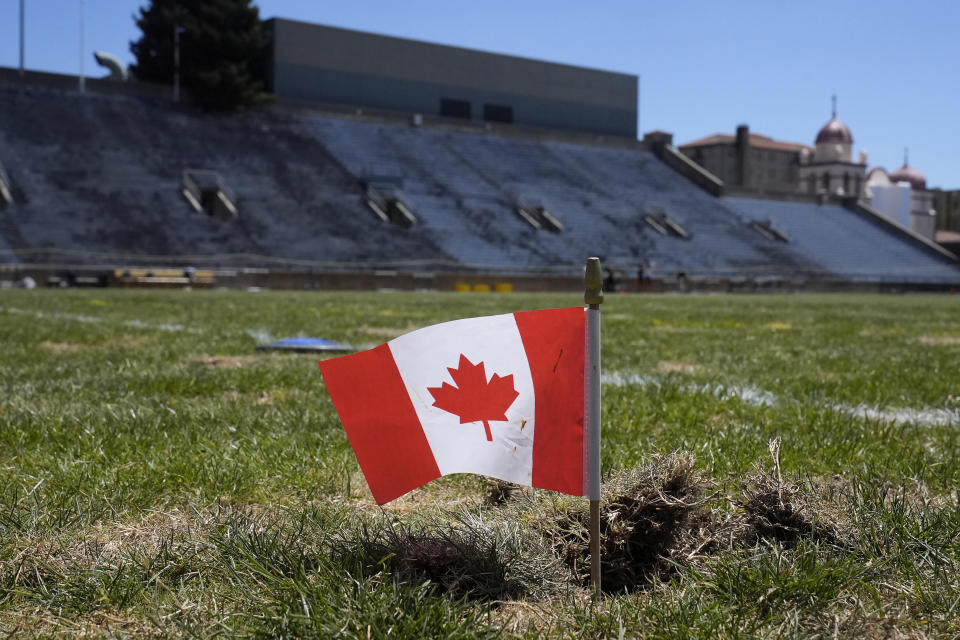 A flag of Canada marks a spot on the field at Edwards Stadium near a discus during a practice in Berkeley, Calif., Thursday, May 2, 2024. (AP Photo/Jeff Chiu)