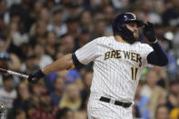 Milwaukee Brewers' Rowdy Tellez watches his RBI single during the fourth inning of the team's baseball game against the Chicago White Sox on Friday, July 23, 2021, in Milwaukee. (AP Photo/Aaron Gash)