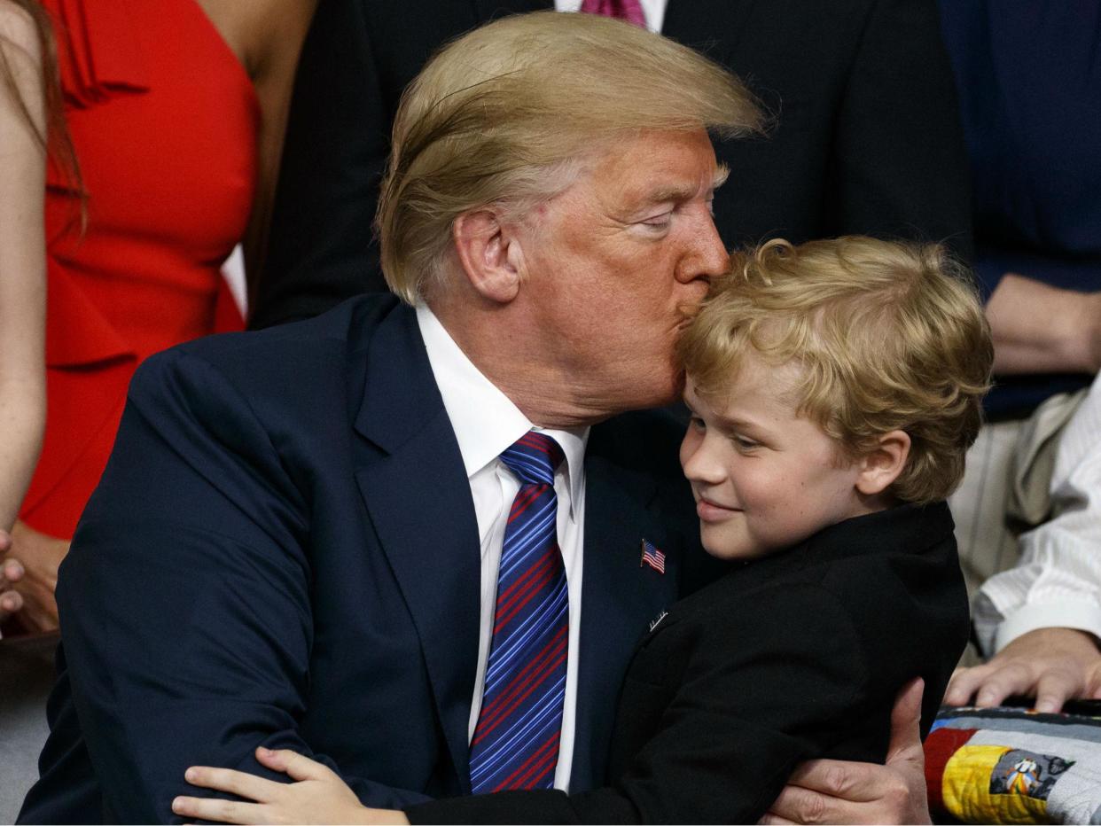 Mr Trump embraces a child with muscular dystrophy after signing the right to try law: AP