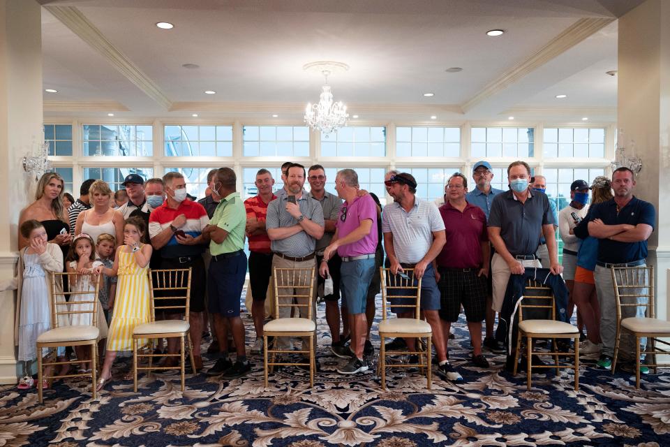 Country club members, few wearing facemasks, await the US president's arrival ahead of a news conference in Bedminster, New Jersey, on August 7, 2020.  / Credit: Jim Watson/Getty Images