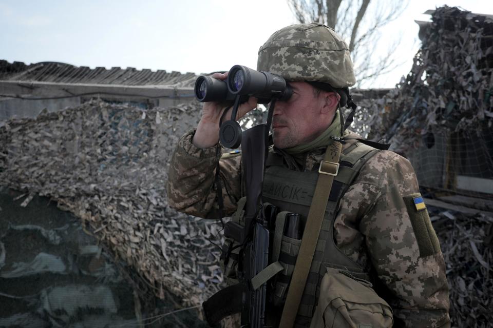 A Ukrainian serviceman patrols at a checkpoint in the village of Shyrokyne, near Mariupol, the last large city in eastern Ukraine controlled by Kyiv, on April 26, 2021. / Credit: ALEKSEY FILIPPOV/AFP/Getty