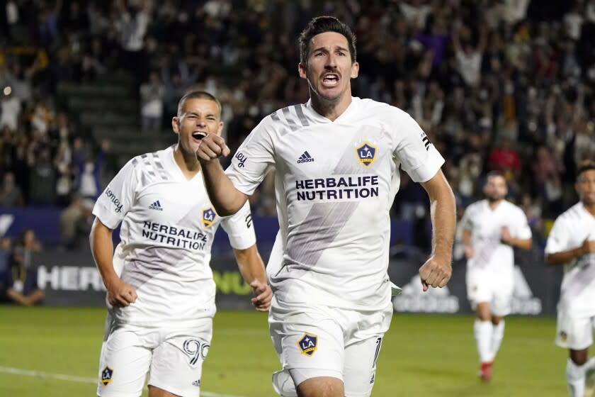 LA Galaxy midfielder Sacha Kljestan, center, celebrates after scoring.