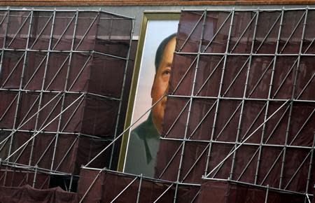 A giant portrait of China's late leader Mao Zedong, which is surrounded by scaffolding during decoration work, is pictured at the Tiananmen Gate in Beijing in this August 28, 2013 file photo. REUTERS/Jason Lee/Files (CHINA - Tags: POLITICS BUSINESS)