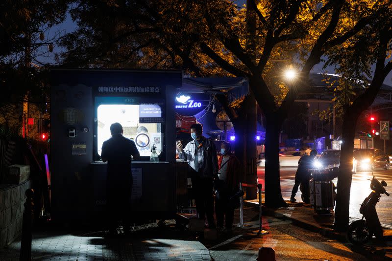 People line up to get a swab at a nucleic acid testing station, set up city-wide to trace possible coronavirus disease (COVID-19) outbreaks in Beijing