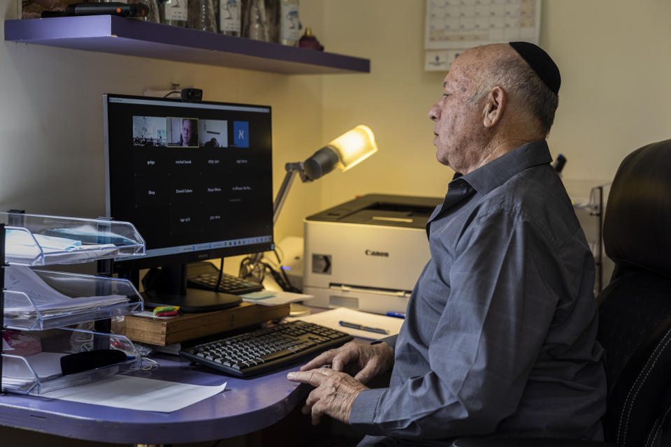 Dr Shmuel Rosenman, chairman of March of the Living gives an online lecture at his house in Moshav Hemed, Israel, Wednesday, April 7, 2021. The March of the Living is saluting medical heroes this year. The annual Holocaust education event is usually marked with a march on the grounds of the former Auschwitz death camp in Poland. But for a second straight year it is being held virtually due to the coronavirus pandemic. (AP Photo/Tsafrir Abayov)