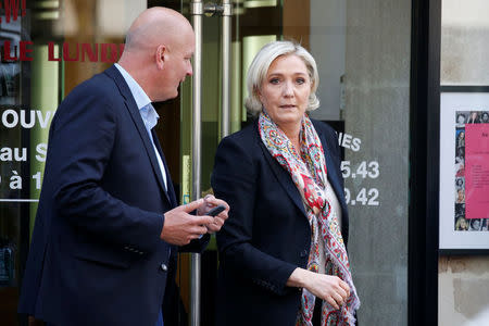 Marine Le Pen (R), French National Front (FN) political party leader and candidate for French 2017 presidential election, and her bodyguard Thierry Legier leave the haidresser in front of her campaign headquarters in Paris, France, April 24, 2017 the day after the first round of presidential elections where Le Pen ended in second place behind En Marche ! movement candidate. REUTERS/Charles Platiau