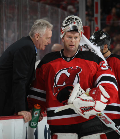 NEWARK, NJ - APRIL 19: Martin Brodeur #30 of the New Jersey Devils and assistant coach Larry Robinson confer during the third period in the game against the Florida Panthers in Game Four of the Eastern Conference Quarterfinals during the 2012 NHL Stanley Cup Playoffs at Prudential Center on April 19, 2012 in Newark, New Jersey. (Photo by Bruce Bennett/Getty Images)