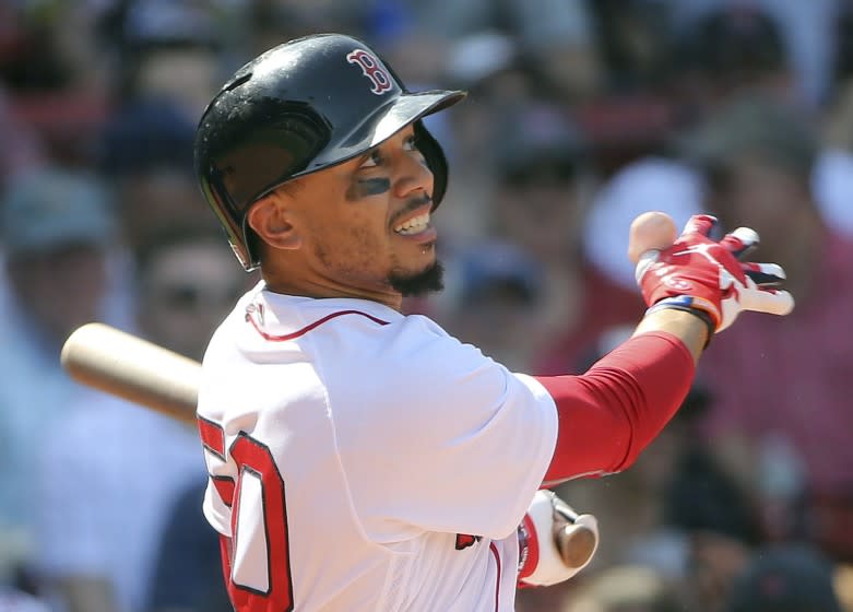 Boston Red Sox's Mookie Betts follows through with his third home run of the game in the seventh inning of a baseball game against the Kansas City Royals at Fenway Park, Wednesday, May 2, 2018, in Boston. (AP Photo/Elise Amendola)