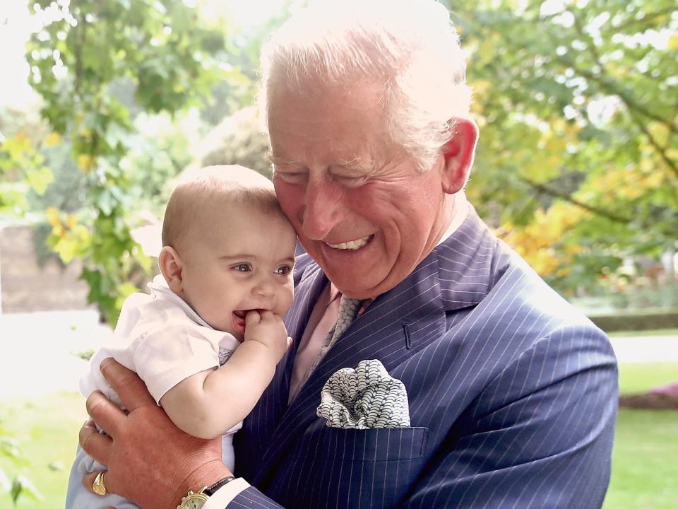 Prince Charles holds Prince Louis